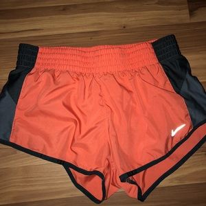 Orange Nike running shorts